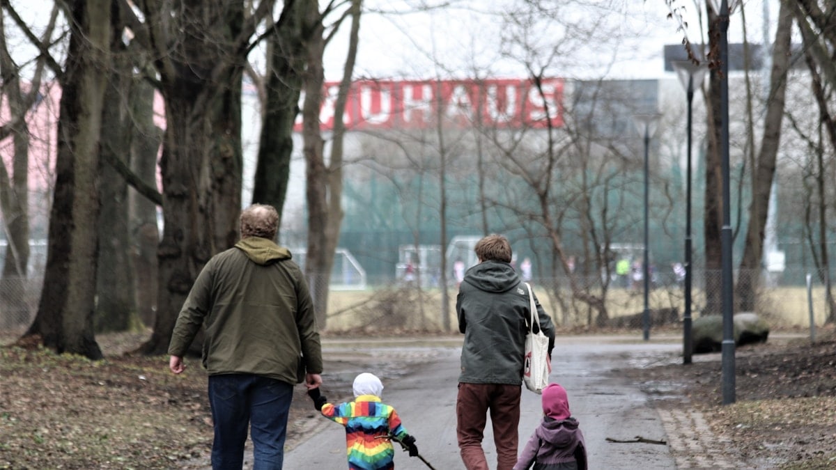 a family walking down a street holding hands